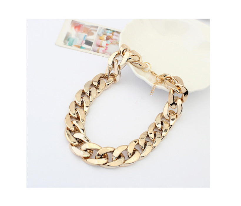 Gold Cuban-link dog chain laid in a loop